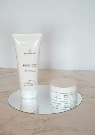 a bottle of cream next to a tube of cream
