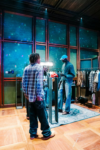 People browse clothing in a stylish store.