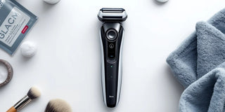 Modern electric shaver with grooming accessories on white.