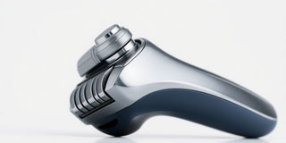 Close-up of a sleek electric razor on a bright background.