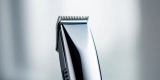 Close-up of a stainless steel nose hair clipper.