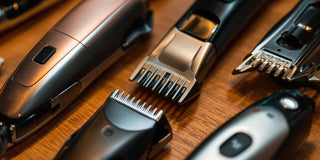 Close-up of hair trimmers and clippers on wood.