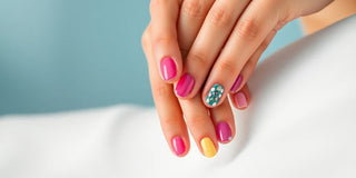 Colorful manicured nails on a serene background.