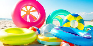 Colorful water toys on a sunny beach for summer fun.