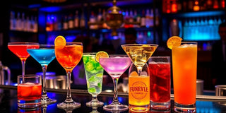 Colorful cocktails in unique glassware at a bar.