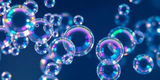 Colorful water bubbles floating in a clear liquid.